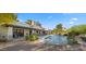 Resort-style backyard features a sparkling pool, patio, and mature landscaping creating a private oasis at 10025 E Larkspur Dr, Scottsdale, AZ 85260