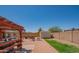 Expansive backyard with a large paved patio, barbecue, outdoor seating, and storage shed at 102 E Angela Dr, Phoenix, AZ 85022