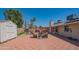 Spacious backyard with patio area, outdoor seating, storage shed, and mature trees at 102 E Angela Dr, Phoenix, AZ 85022