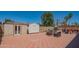 Well-maintained backyard featuring a patio area, outdoor seating, and storage sheds at 102 E Angela Dr, Phoenix, AZ 85022