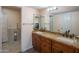 Bathroom with double vanity and granite countertop, plus a walk-in shower, designed for comfort and style at 102 E Angela Dr, Phoenix, AZ 85022