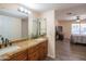 Bathroom featuring a granite-topped double vanity and a connecting bedroom, offering both style and convenience at 102 E Angela Dr, Phoenix, AZ 85022