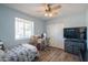 Bedroom with a bright window, ceiling fan, and closet, plus desk area, offering comfort and convenience at 102 E Angela Dr, Phoenix, AZ 85022