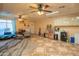 Large bonus room featuring unique tiled floor, ceiling fans and convenient access to outdoor area at 102 E Angela Dr, Phoenix, AZ 85022