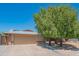 Charming single-story home with a large front yard tree and a two car garage at 102 E Angela Dr, Phoenix, AZ 85022