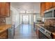 Open-concept kitchen with stainless steel appliances, granite counters, and views of the Gathering room at 102 E Angela Dr, Phoenix, AZ 85022
