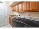 A well-appointed laundry room with modern appliances and ample cabinet space at 102 E Angela Dr, Phoenix, AZ 85022