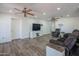 Comfortable open-concept living room featuring wood look floors and ceiling fans at 102 E Angela Dr, Phoenix, AZ 85022