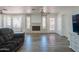 Spacious living room showcasing fireplace, large windows, and modern flooring, ideal for relaxation and Gathering time at 102 E Angela Dr, Phoenix, AZ 85022
