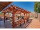 Spacious pergola area with seating, BBQ, and an outdoor kitchen setup, great for outdoor gatherings at 102 E Angela Dr, Phoenix, AZ 85022