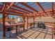 View of covered outdoor area with stylish pergola, built-in benches, and a grill, perfect for entertaining at 102 E Angela Dr, Phoenix, AZ 85022