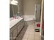 Bright bathroom features a soaking tub, enclosed shower, double sink vanity, and tile flooring at 11360 E Keats Ave # 75, Mesa, AZ 85209