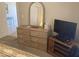 Bedroom dresser with mirror and television next to doorway at 11360 E Keats Ave # 75, Mesa, AZ 85209