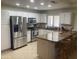 Modern kitchen featuring stainless steel appliances, white cabinets, and granite countertops with a breakfast bar at 11360 E Keats Ave # 75, Mesa, AZ 85209