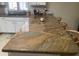 Close-up of kitchen bar area showcasing granite countertops and wooden bar stools at 11360 E Keats Ave # 75, Mesa, AZ 85209