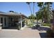 Spacious covered patio and outdoor pool with lush landscaping and tall palm trees at 12601 N 34Th St, Phoenix, AZ 85032