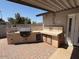 Backyard featuring an outdoor kitchen with custom tile accents at 12601 N 34Th St, Phoenix, AZ 85032