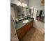 Bathroom features a large mirror, wooden cabinets, and a marble countertop at 12601 N 34Th St, Phoenix, AZ 85032
