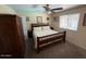 Bedroom with a wood-frame bed, armoire, and neutral colors at 12601 N 34Th St, Phoenix, AZ 85032