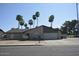 Charming single-story home featuring a brick facade, attached garage, and well-maintained landscaping with mature palm trees at 12601 N 34Th St, Phoenix, AZ 85032