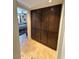 Hallway with dark stained cabinetry and view into bedroom at 12601 N 34Th St, Phoenix, AZ 85032