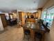 Open-concept kitchen with natural wood cabinetry, granite countertops, stainless appliances, and an eat-in island at 12601 N 34Th St, Phoenix, AZ 85032