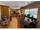 Bright kitchen featuring wooden cabinetry, granite countertops, stainless appliances, and pool views at 12601 N 34Th St, Phoenix, AZ 85032