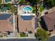 A solar panel equipped home features a beautiful backyard with a sparkling pool and lush landscaping at 13323 W Rancho Dr, Litchfield Park, AZ 85340