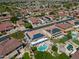 Expansive aerial view of a residential neighborhood featuring single-Gathering homes with pools and solar panels on roofs at 13323 W Rancho Dr, Litchfield Park, AZ 85340