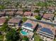 A home with solar panels has a pool and backs onto a greenbelt in a neighborhood with lush landscaping at 13323 W Rancho Dr, Litchfield Park, AZ 85340