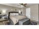 This bedroom features neutral tones, a ceiling fan and lots of decorative touches and natural light at 13323 W Rancho Dr, Litchfield Park, AZ 85340