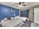 A light and airy bedroom featuring a blue accent wall, window and gray neutral walls at 13323 W Rancho Dr, Litchfield Park, AZ 85340