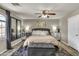This bedroom features neutral tones, a ceiling fan and lots of decorative touches and natural light at 13323 W Rancho Dr, Litchfield Park, AZ 85340
