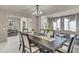 Bright dining room with a dark wooden table, elegant chairs, and flowers on the table at 13323 W Rancho Dr, Litchfield Park, AZ 85340