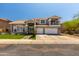 Two-story home with a three-car garage and well-manicured front yard at 13323 W Rancho Dr, Litchfield Park, AZ 85340