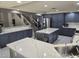 Spacious kitchen with blue cabinets, quartz countertops, stainless steel appliances, and a large center island at 13323 W Rancho Dr, Litchfield Park, AZ 85340