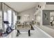 Bright living room with a foosball table, exercise bike and ample natural light at 13323 W Rancho Dr, Litchfield Park, AZ 85340