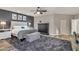 The main bedroom has wood floors, a dark accent wall, and a comfy sitting area with an area rug at 13323 W Rancho Dr, Litchfield Park, AZ 85340