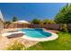 Relaxing backyard pool with a sun umbrella, perfect for summer days at 13323 W Rancho Dr, Litchfield Park, AZ 85340