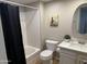 Cozy bathroom with decorative shower curtain, toilet, vanity and round mirror at 1432 W Emerald Ave # 686, Mesa, AZ 85202
