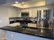 Updated kitchen boasting stainless steel appliances and stylish black granite countertops at 1432 W Emerald Ave # 686, Mesa, AZ 85202