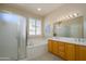 Bathroom featuring a separate shower, soaking tub, double sinks, and natural light from a large window at 15134 W Waterford Dr, Surprise, AZ 85374