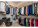 Walk-in closet with custom shelving and hanging rods, providing ample storage space for clothes and accessories at 15134 W Waterford Dr, Surprise, AZ 85374