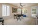 Cozy dining area with shuttered windows, a ceiling fan, and access to the patio at 15134 W Waterford Dr, Surprise, AZ 85374