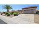 Well-maintained house with a two-car garage, desert landscaping, and a clean sidewalk at 15134 W Waterford Dr, Surprise, AZ 85374