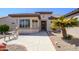 Attractive home exterior with a bay window, palm tree, and landscaped yard at 15134 W Waterford Dr, Surprise, AZ 85374