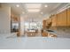 Bright kitchen with stainless steel appliances, center island, and an adjacent breakfast nook filled with natural light at 15134 W Waterford Dr, Surprise, AZ 85374