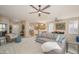 Open-concept living room with neutral tones, plenty of seating, and an adjacent kitchen at 15134 W Waterford Dr, Surprise, AZ 85374