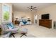 Bright main bedroom with a seating area, TV, and ample space for comfortable living at 15134 W Waterford Dr, Surprise, AZ 85374