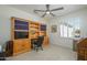 Bright home office with a custom-built bookcase, desk, and a window at 15134 W Waterford Dr, Surprise, AZ 85374